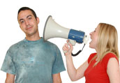 Photograph of two students, one shouting through a loudspeaker