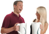 Photograph of two students, each holding a kettle